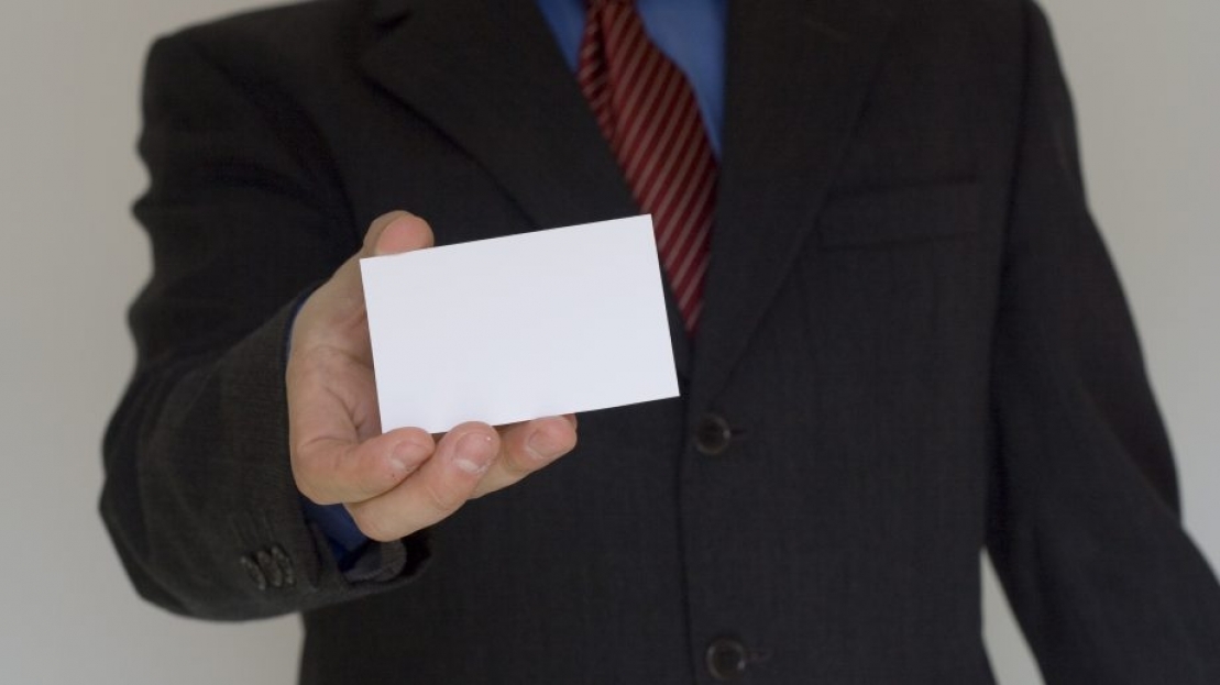 man giving out a blank business card