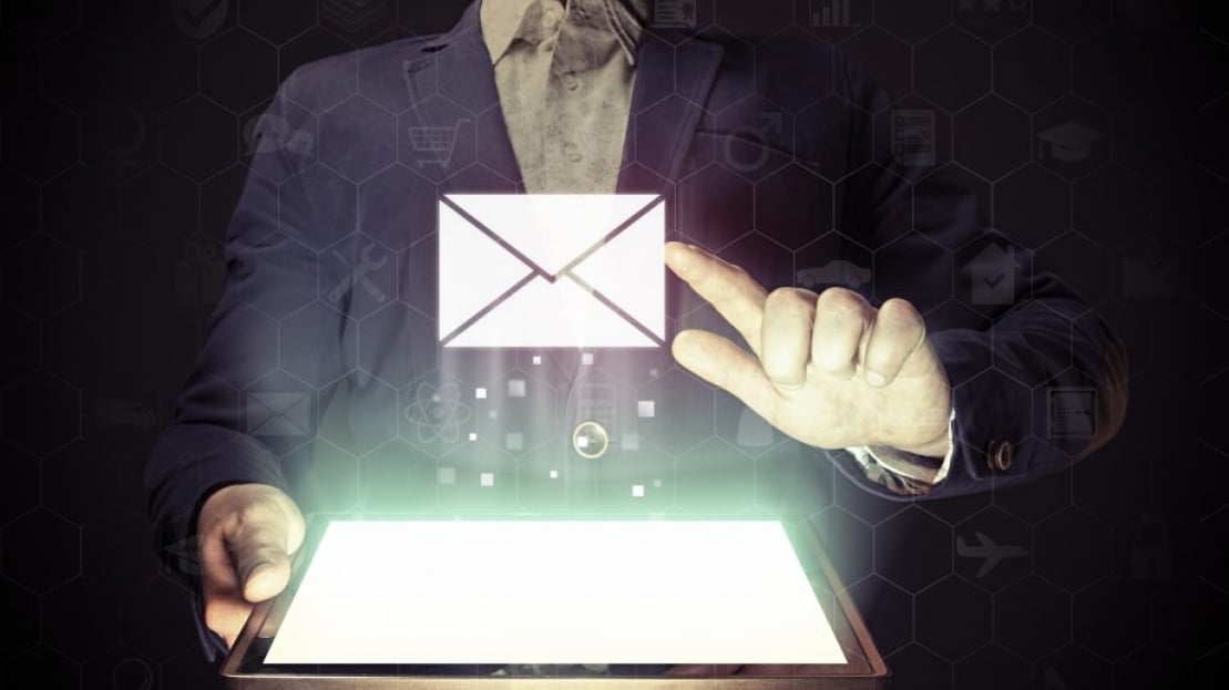 man pressing on a holographic mail icon